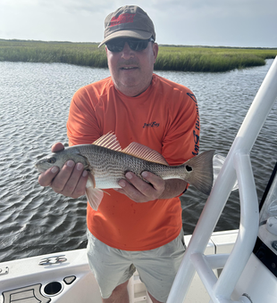 Reeling in the redfish with light tackle on a cloudy day!