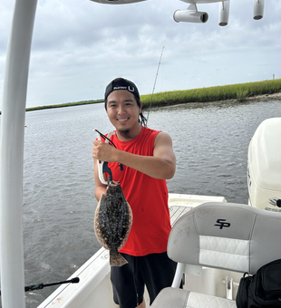 Reeling in an 11-inch Summer Flounder on a partly cloudy day!