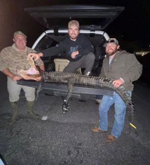 Smiles Over their successful gator hunt - Panacea, FL.