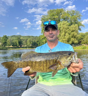 Landing a big Smallmouth Bass while fly fishing in Stanwood!