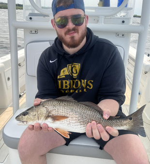Reeling in a fiery red catch on a partly cloudy day with a chance of late rain