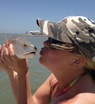 Playful moment with a Port O’Connor Redfish catch