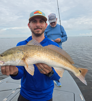 Big redfish reeled in during a partly cloudy day with light tackle!