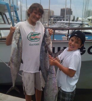 Novice angler's wide smiles with their prized fish