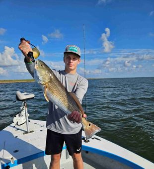 Hooking into hard-fighting redfish on the shallow flats of Corpus Christi, TX.