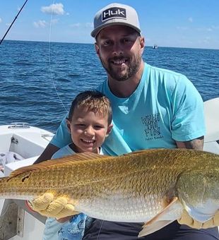This kid got this huge Redfish with his dad!