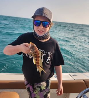 My boy with his catch, a Sand Bass