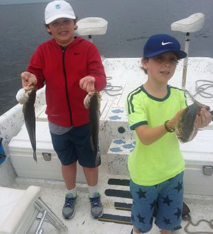 Happy young anglers with Spanish mackerel catch