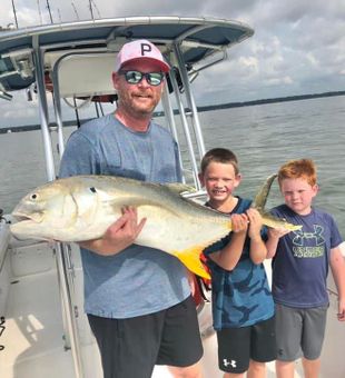 Kids enjoying large catch, Crevalle Jack