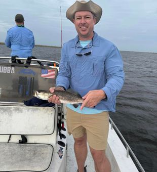 Happy angler lands a solid Speckled Trout