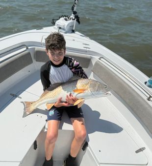 His first trophy redfish from Charleston, SC