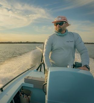 Captain Cullen on a boat during sunset.