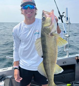"Reelin’ in the big one!" Nothing beats a day on the water with a trophy walleye in hand!"
