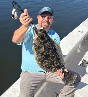 Flounder catch, angler smiles