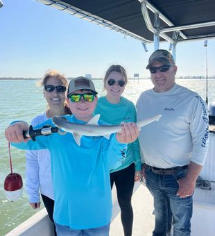 Smiling crew and a small shark