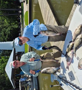 Smiling with a hefty striped bass haul!