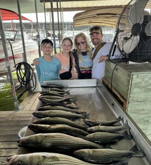 Happy family with a great striped bass catch