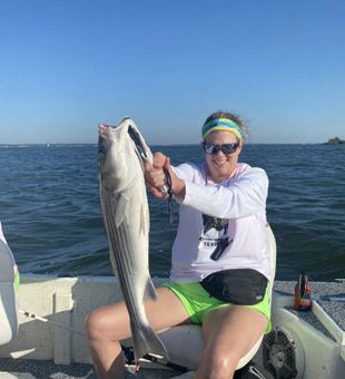 Excited angler with a big striped bass.