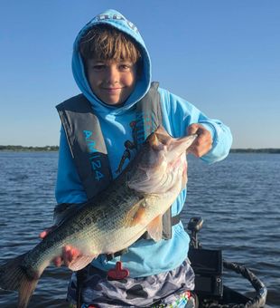 Cooper with a giant bass caught on a texas rig ol monster II plum worm