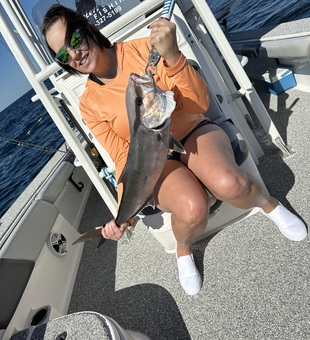 Fishing the clear waters of Pensacola, Florida, with a light tackle in the early morning rain.