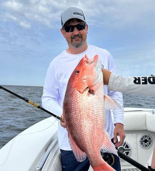 Strong Red Snapper catch on calm water.