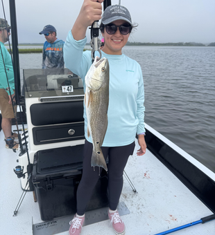 Light tackle magic: Reeling in a redfish as the clouds part!
