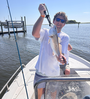 Reeling in a redfish while deep sea trolling off Wilmington's coast!