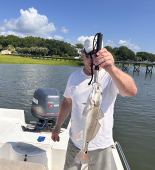 Reeling in the redfish with light tackle in cloudy Wilmington waters!