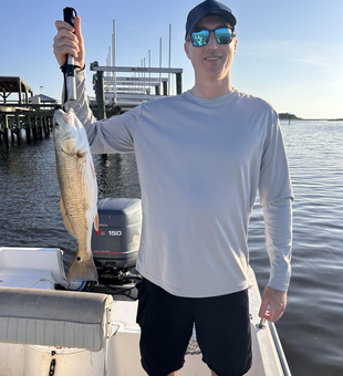 Reeling in a redfish on a clear day in Wilmington!