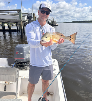 A thrilling day hauling in a prized Redfish on the open waters of Wilmington!