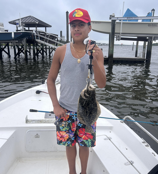 Light tackle triumph: A 12-inch Summer Flounder reeled in!