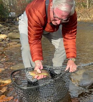 Fly fishing adventure on the Nantahala River with mountain views and clear water.
