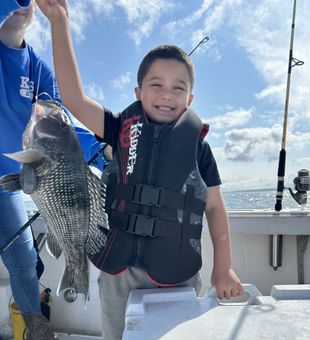 Big smiles and a solid Black Sea Bass!