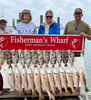 Happy family haul with redfish and sheepshead at Port Aransas fishing dock