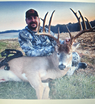 Exciting white-tailed deer harvest with impressive antlers in partly cloudy conditions.