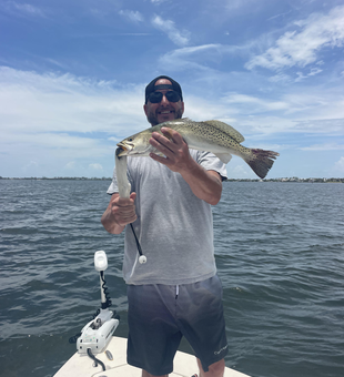 Reeling in a Spotted Weakfish on a cloudy day in Holmes Beach!