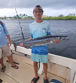 Proud Wahoo catch on a cloudy Cayman day!