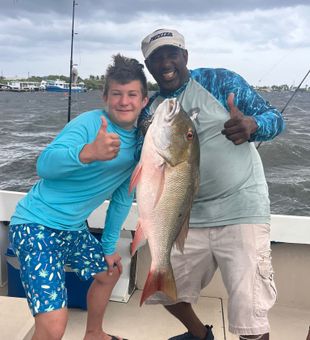 Excited team with a hefty Snapper!