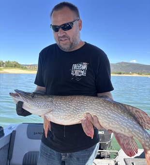 Nice Northern Pike using deep sea jigging technique in partly cloudy conditions.