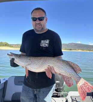 Nice Northern Pike using deep sea jigging and trolling techniques in partly cloudy conditions.