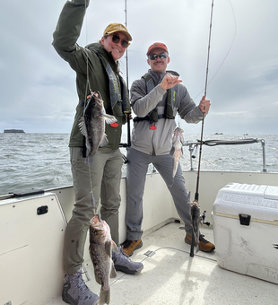 Couple catch a pair of fish on a rainy Seattle day.