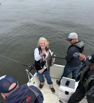 Reeling in a Black Rockfish on Seattle's moody waters!