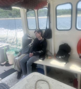 Reeling in the best catch of the day under partly cloudy skies.