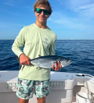 Proud angler with a prized bonito catch.