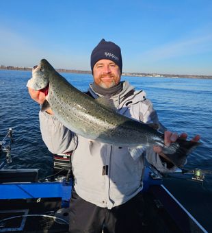 Reeling in powerful salmon just offshore of Port Washington on Lake Michigan, Wisconsin.