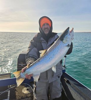 Sunrise bite heating up on a Port Washington, WI salmon fishing charter along Lake Michigan’s productive waters.