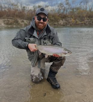 Angler reeling in a trophy Trout in WNY waters