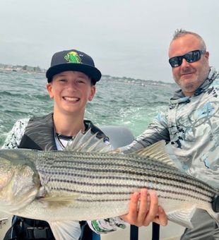 Striped bass action heats up while fishing Massachusetts Bay out of downtown Scituate, MA.