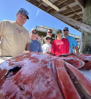 Nice catch ready for cleaning at the dock! Clear conditions made for an exciting day on the water.