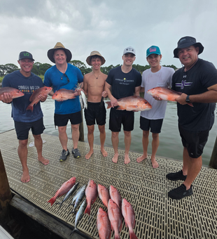 Reeling in Red Snappers on a partly cloudy day in Gulf Shores!